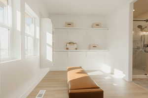 Bathroom with baseboards, visible vents, and wood finished floors