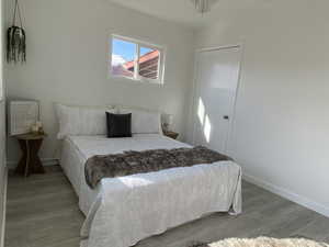 Bedroom featuring light wood-style floors and baseboards