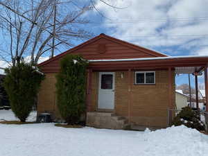 View of front of home featuring entry steps and brick siding