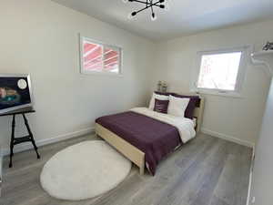 Bedroom featuring light wood finished floors and baseboards