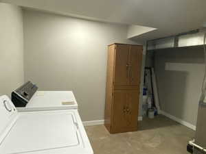 Laundry room featuring laundry area, baseboards, and washing machine and clothes dryer