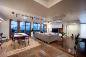 Living room featuring concrete floors, baseboards, a textured ceiling, and a wall mounted air conditioner