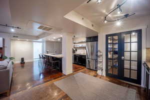 Interior space with visible vents, a textured ceiling, and baseboards