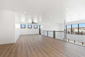 Empty room featuring recessed lighting, ceiling fan, baseboards, and wood finished floors