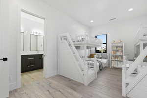 Bedroom with recessed lighting, visible vents, light wood-style flooring, and baseboards