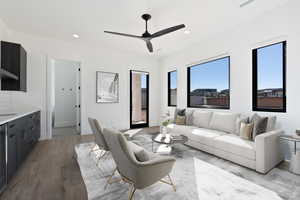 Living room featuring recessed lighting, ceiling fan, wood finished floors, beverage cooler, and baseboards