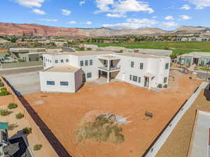 Exterior space with a residential view, a mountain view, fence, and stucco siding