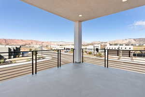 View of patio featuring a balcony and a mountain view