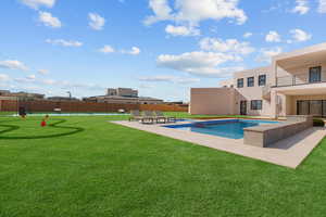 View of pool with a yard, a patio, fence, and a fenced in pool