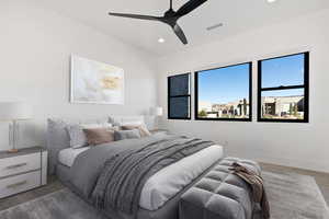 Bedroom featuring recessed lighting, visible vents, light wood-style flooring, a ceiling fan, and baseboards