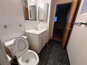 Bathroom featuring vanity and toilet