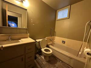 Full bathroom with toilet, vanity, and a bath