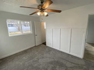 Unfurnished bedroom with carpet floors, a closet, and ceiling fan