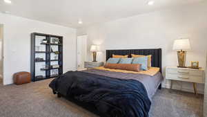 Carpeted bedroom with baseboards and recessed lighting