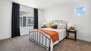 Carpeted bedroom featuring visible vents and baseboards