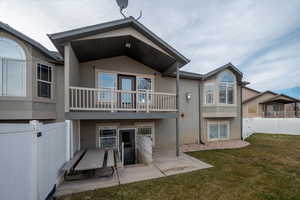 Back of home with covered deck & covered patio