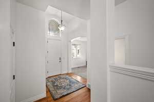 Front entry with arched window and formal living room that could double as an office or den