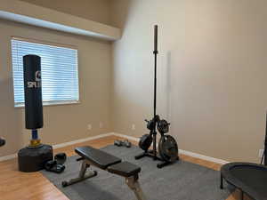 Exercise room with baseboards and wood finished floors