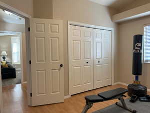 Exercise area featuring light wood finished floors and baseboards