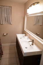 Bathroom with tile patterned flooring and vanity