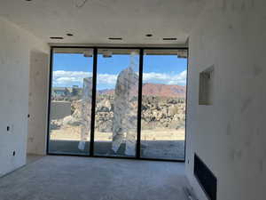 Interior space featuring concrete floors and a wall of windows