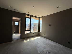 Empty room featuring recessed lighting and concrete floors