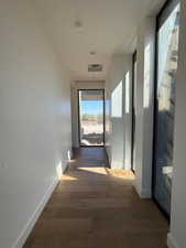 Hall featuring baseboards and wood finished floors