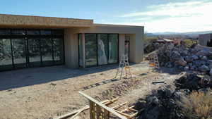 Entrance to property with a mountain view and stucco siding