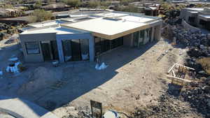 Rear view of property with stucco siding