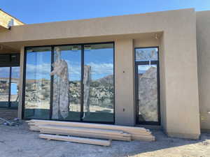 Entrance to property with stucco siding