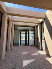 Entrance to property with stucco siding