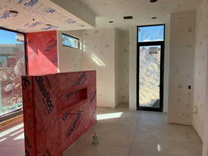 Interior space featuring floor to ceiling windows and light tile patterned flooring