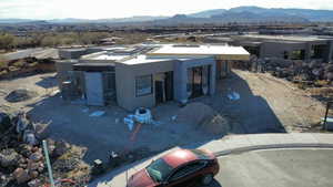 View of front of home with a mountain view and stucco siding