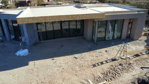 Rear view of house featuring stucco siding