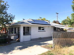 View of front of home featuring solar panels and covered porch