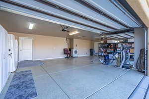 Garage with a garage door opener, washer / dryer, and baseboards