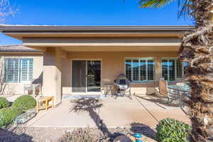 Back of house with a patio area and stucco siding