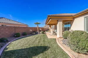 View of yard featuring a fenced backyard and a patio