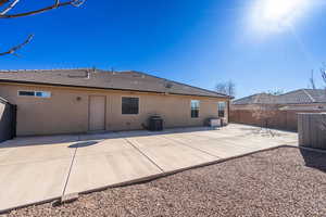 Rear view of house with a tiled roof, fence, central air condition unit, a patio area, and stucco siding