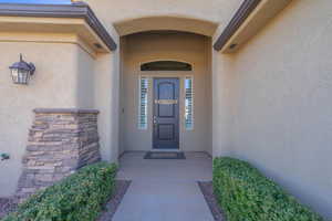 View of exterior entry featuring stucco siding