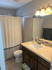 Full bathroom featuring visible vents, vanity, toilet, and tile patterned floors