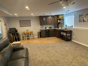 Living room with recessed lighting, baseboards, a ceiling fan, and light colored carpet