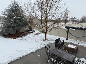 Yard layered in snow with a fenced backyard