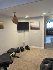 Workout room with carpet and baseboards