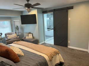 Bedroom with light carpet, a barn door, a ceiling fan, and baseboards