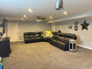 Living room with baseboards, carpet floors, ceiling fan, and recessed lighting