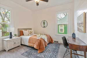 Bedroom featuring light carpet and multiple windows