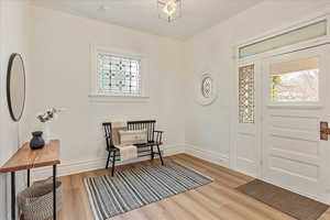 Foyer with light wood-type flooring and baseboards