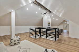 Bonus room featuring vaulted ceiling with beams, recessed lighting, wood finished floors, and baseboards