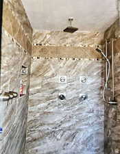 Bathroom featuring a tile shower